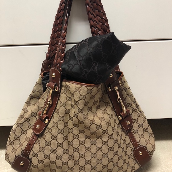Authentic Gucci hobo bag with classic "GG" print.